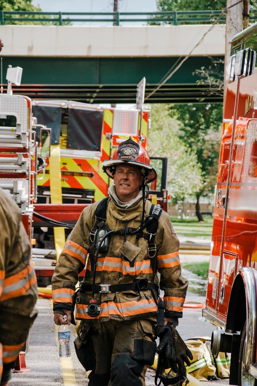 Fire captain walking between staged fire apparatus